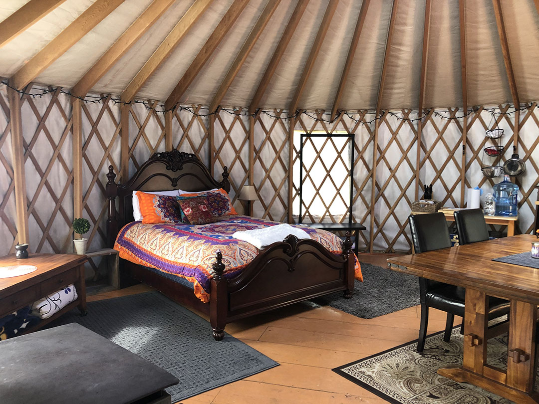 Bed and furniture inside a yurt